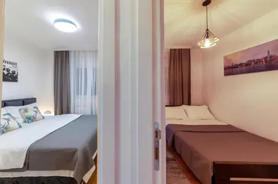 a small room with two beds and a window at Apartment SIX - free parking in Belgrade