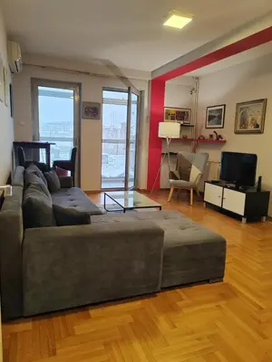 a living room with a couch and a television at Flat near Belgrade Waterfront in Belgrade