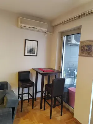 a living room with a table and two chairs at Flat near Belgrade Waterfront in Belgrade