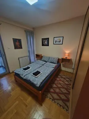 a small bedroom with a bed and a rug at Flat near Belgrade Waterfront in Belgrade