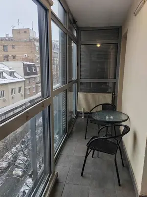 a balcony with a table and chairs and windows at Flat near Belgrade Waterfront in Belgrade