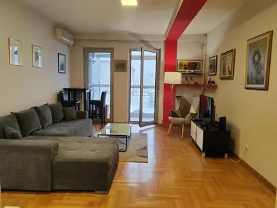 a living room with a couch and a television at Flat near Belgrade Waterfront in Belgrade