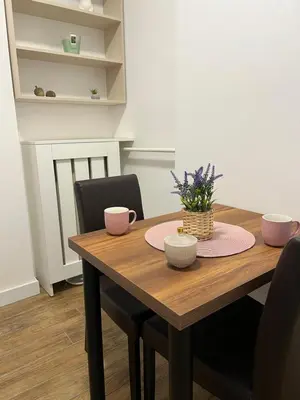 a dining room table with pink bowls on it at Saint Mark in Belgrade