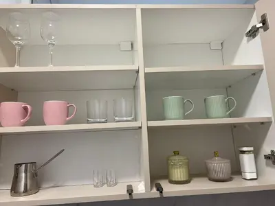 a kitchen shelf with cups and mugs on it at Saint Mark in Belgrade