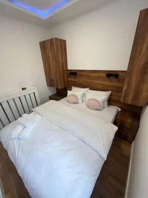 a bedroom with a large bed with white sheets at Saint Mark in Belgrade