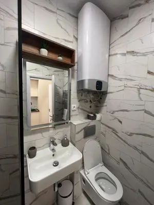 a bathroom with a sink and a toilet and a mirror at Saint Mark in Belgrade