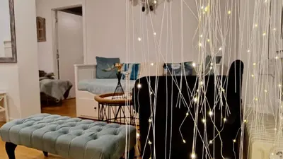 a living room with a couch and a piano at Beolight Apartment in Belgrade