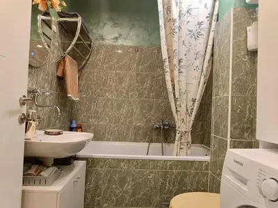a bathroom with a tub and a sink and a toilet at Beolight Apartment in Belgrade