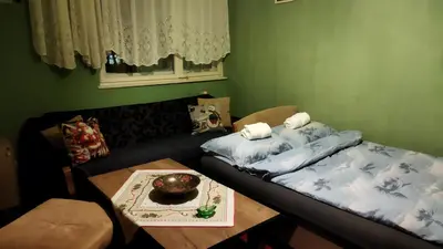 a living room with a couch and a table at Grin in Zemun Polje
