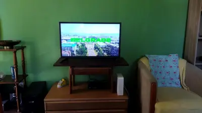 a living room with a flat screen tv on a table at Grin in Zemun Polje