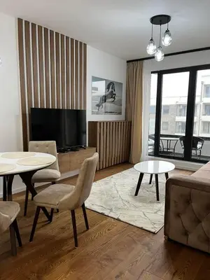 a living room with a television and a couch and tables at Luxury Getaway with Comfort! in Belgrade