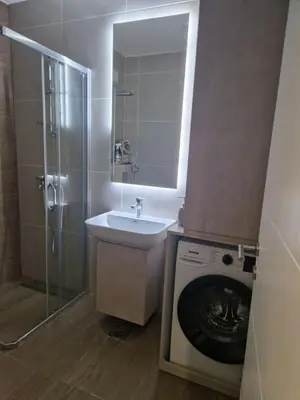 a bathroom with a washing machine and a sink at Luxury Getaway with Comfort! in Belgrade
