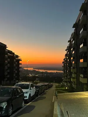 a row of cars parked in a parking lot at sunset at Luxury Getaway with Comfort! in Belgrade