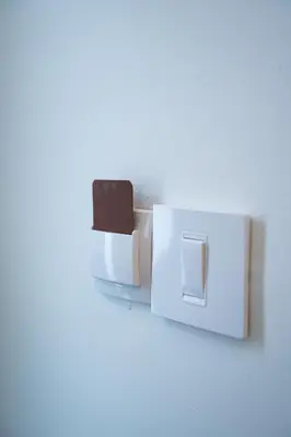 a white light switch on a white wall at Atelier in Belgrade