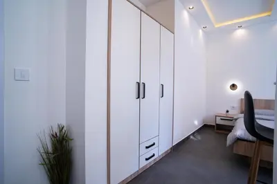 a bedroom with white cabinets and a desk at Atelier in Belgrade