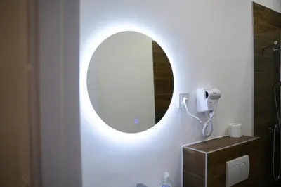 a bathroom with a mirror and a sink at Atelier in Belgrade