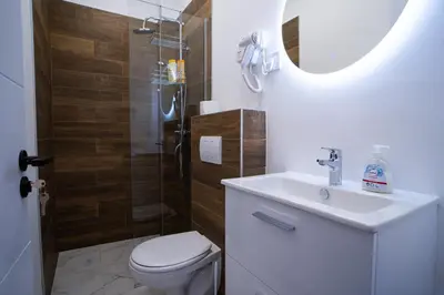 a bathroom with a toilet and a sink and a shower at Atelier in Belgrade