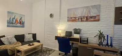 a living room with a couch and a desk at Avalavanda Slavija in Belgrade