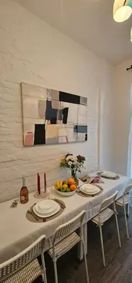 a dining room table with plates and fruit on it at Avalavanda Slavija in Belgrade