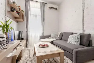 a living room with a couch and a table at Avalavanda Slavija in Belgrade