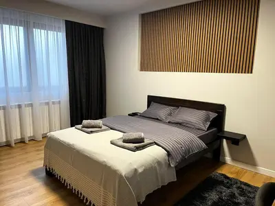 a bedroom with a bed with two towels on it at Surčin Grape Vine Apartments in Surčin