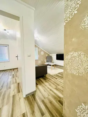 an empty living room with a cross on the wall at Surčin Grape Vine Apartments in Surčin