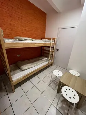 a room with bunk beds and a table and chairs at Bed and Shower Alone in Belgrade