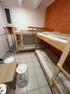 a room with two bunk beds and a table and chairs at Bed and Shower Alone in Belgrade
