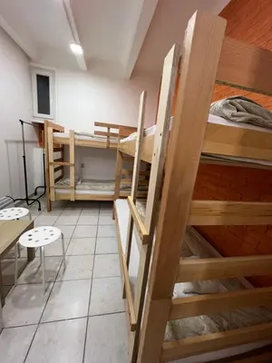 a room with two bunk beds and a table at Bed and Shower Alone in Belgrade