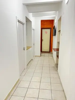 a hallway with a door and a tiled floor at Bed and Shower Alone in Belgrade
