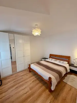 a bedroom with a large bed and a mirror at The White Nest Loft in Belgrade