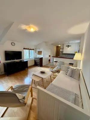 a living room with a couch and a table at The White Nest Loft in Belgrade