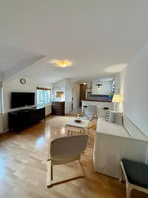 a living room with a couch and a table at The White Nest Loft in Belgrade