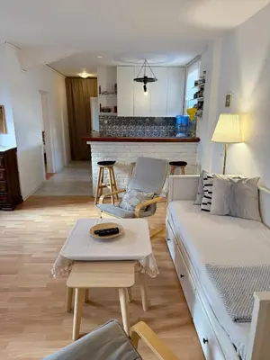 a living room with a couch and a table at The White Nest Loft in Belgrade