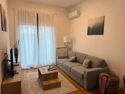 a living room with a couch and a coffee table at Woodstar Apart in Belgrade