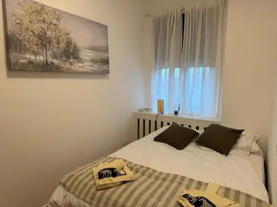 a bedroom with a bed and a window at Woodstar Apart in Belgrade