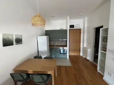 a kitchen with a wooden table and chairs in a room at Woodstar Apart in Belgrade