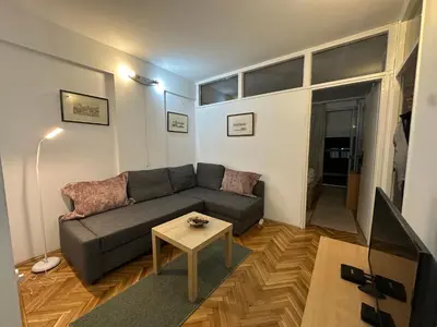 a living room with a couch and a table at City Centre Retreat Pionir Apartment in Belgrade