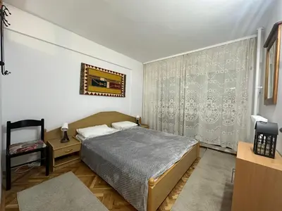 a bedroom with a bed and a chair at City Centre Retreat Pionir Apartment in Belgrade