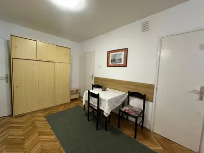 a dining room with a table and chairs in a room at City Centre Retreat Pionir Apartment in Belgrade