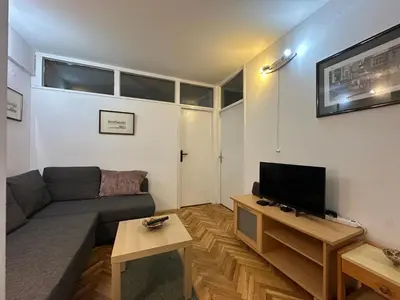 a living room with a couch and a flat screen tv at City Centre Retreat Pionir Apartment in Belgrade