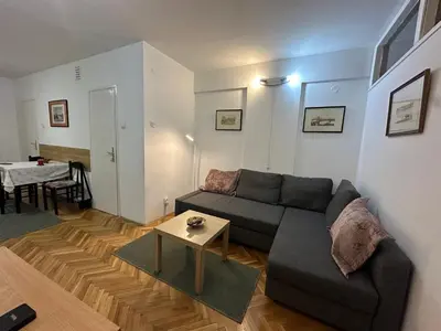 a living room with a couch and a table at City Centre Retreat Pionir Apartment in Belgrade