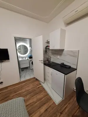a kitchen with white cabinets and a counter top at White City 6 in Belgrade