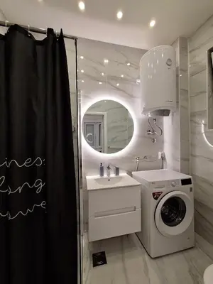 a bathroom with a sink and a washing machine at White City 6 in Belgrade