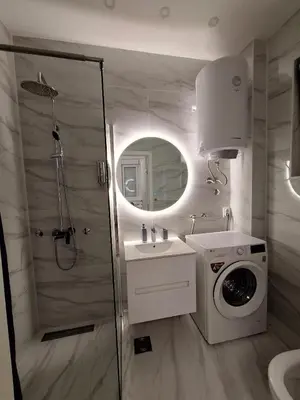 a bathroom with a shower and a washing machine at White City 6 in Belgrade