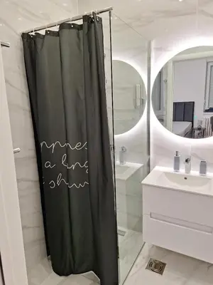 a bathroom with a shower curtain with the words mine a end at White City 6 in Belgrade