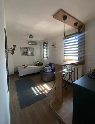 a living room with a table and a couch at Apartment 5th in Belgrade