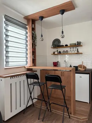 a kitchen with two bar stools and a counter at Apartment 5th in Belgrade