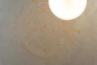 a light hanging from a ceiling with a wall at Casa Novi Dorcol Belgrade in Belgrade