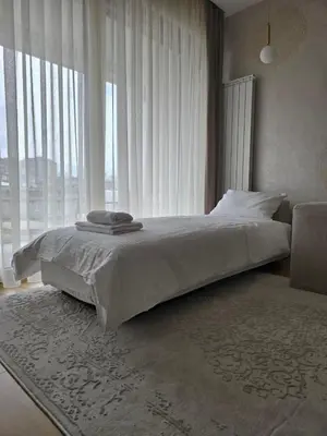 a bedroom with a bed and a large window at Casa Novi Dorcol Belgrade in Belgrade